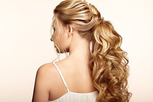 Blonde bride with elegant curly ponytail